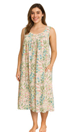 Woman wearing a floral sleeveless nightie dress on a white background