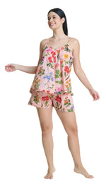 Woman wearing a floral pajama set on a white background
