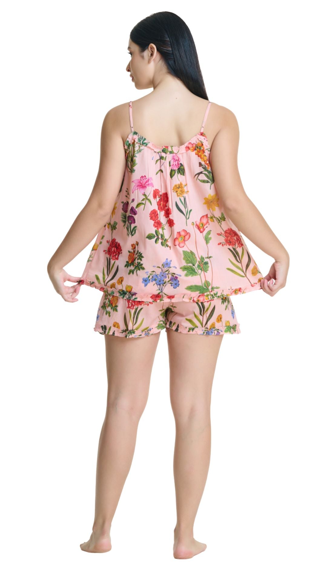 Woman wearing a floral pajama set on a white background