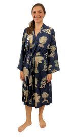 Woman wearing a navy blue robe with palm print on a white background sizes 8 to 30