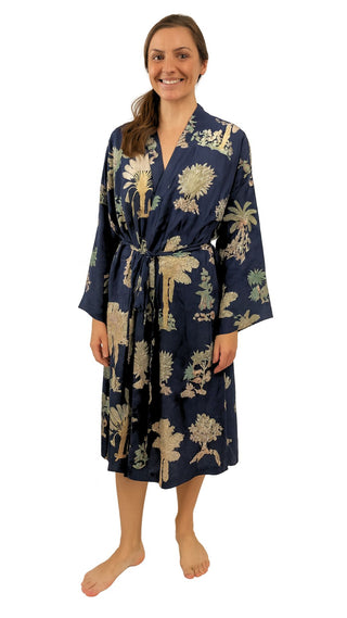 Woman wearing a navy blue robe with palm print on a white background sizes 8 to 30