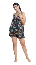 Woman wearing a floral PJ set on a white background