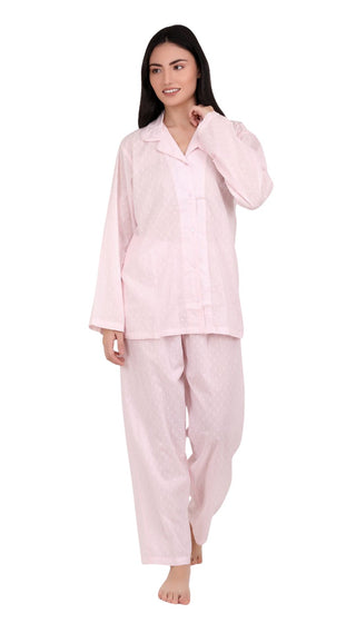 Woman wearing a pink pajama set on a white background