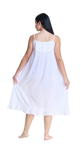 Woman wearing a white slip dress on a white background