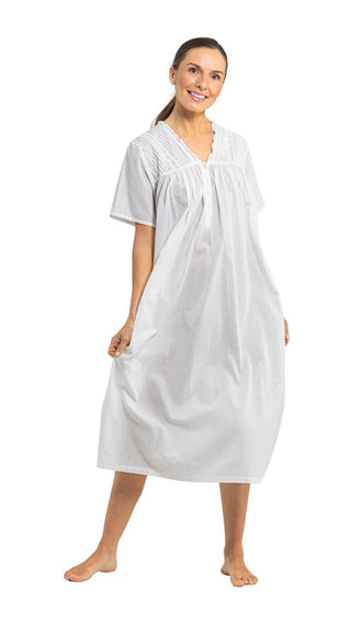 Woman wearing a white nightgown on a white background