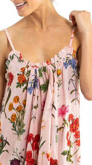 Woman wearing a floral dress with colorful flowers on a white background