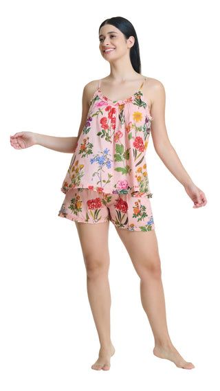 Woman wearing a floral pajama set on a white background