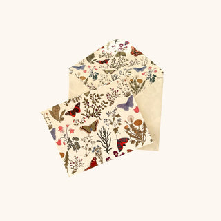 Decorative envelope with floral and butterfly pattern on a white background